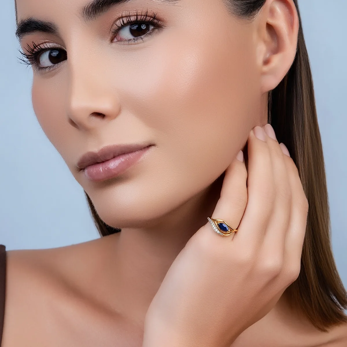 Anillo en oro amarillo de 18 Kilates, con zafiro central de 0.50 Ct y decoración en diamantes de 0.07 Ct