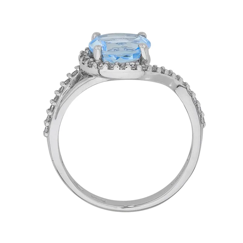 Anillo en oro blanco de 18 Kilates, con topacio central y decoración en zircones