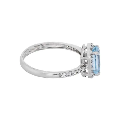 Anillo en oro blanco de 18 Kilates, con topacio central y decoración en zircones