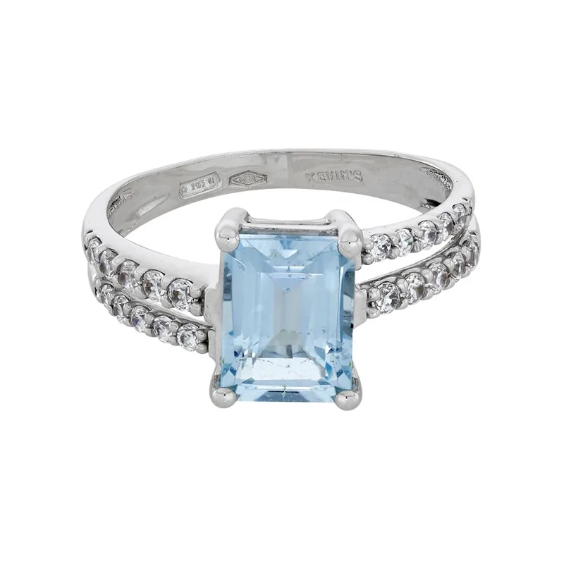 Anillo en oro blanco de 18 Kilates, con topacio central y decoración en zircones
