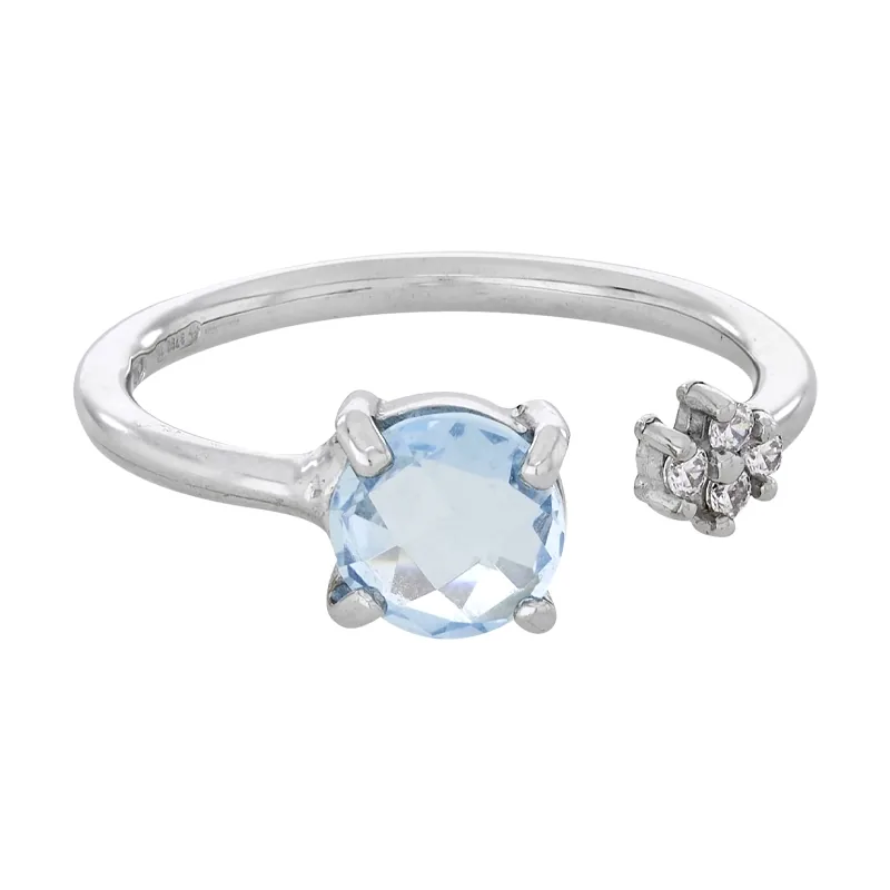 Anillo en oro blanco de 18 Kilates, con topacio central y decoración en zircones