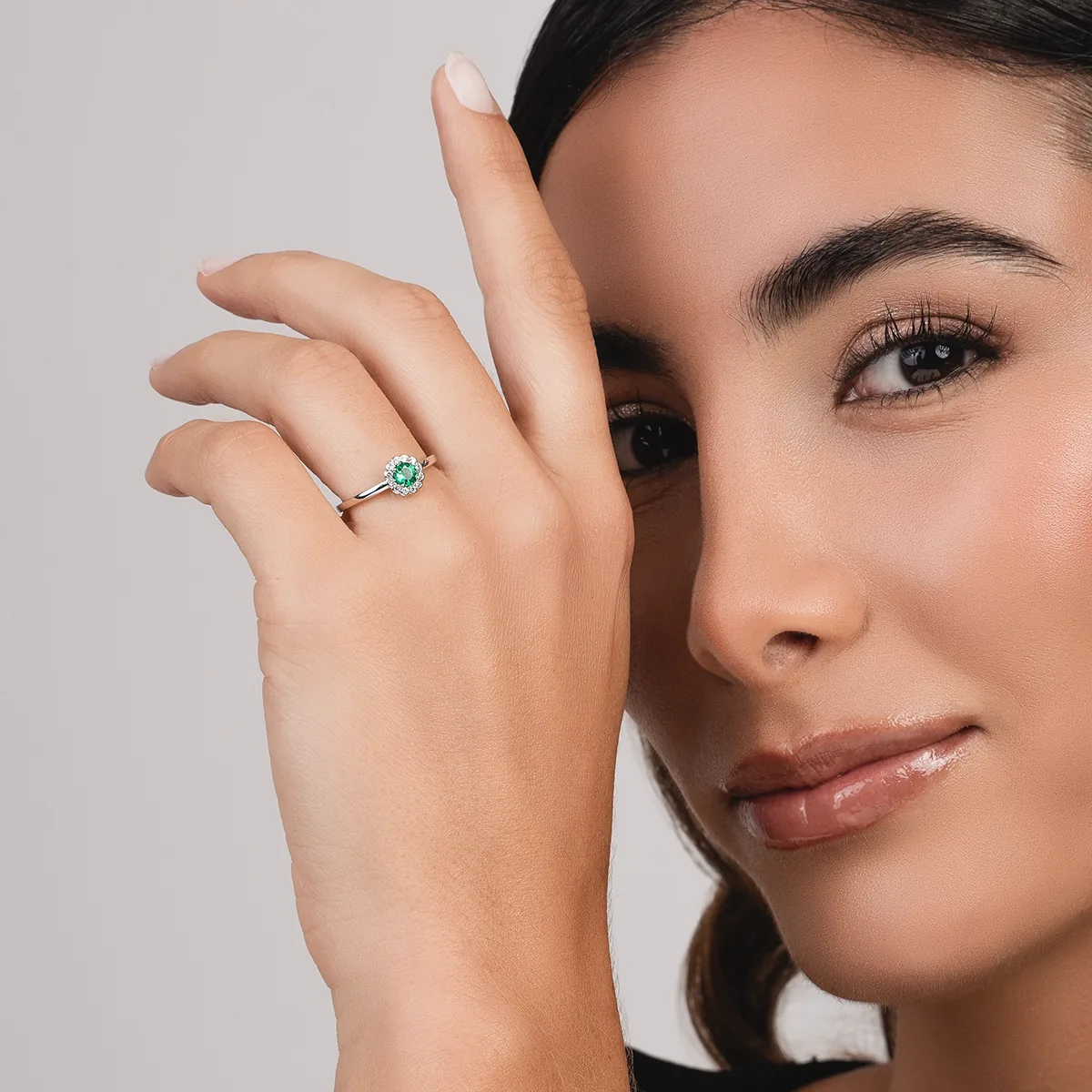 Anillo en oro blanco de 18 Kilates, con esmeralda central de 0.25 Ct y decoración en diamantes de 0.10 Ct