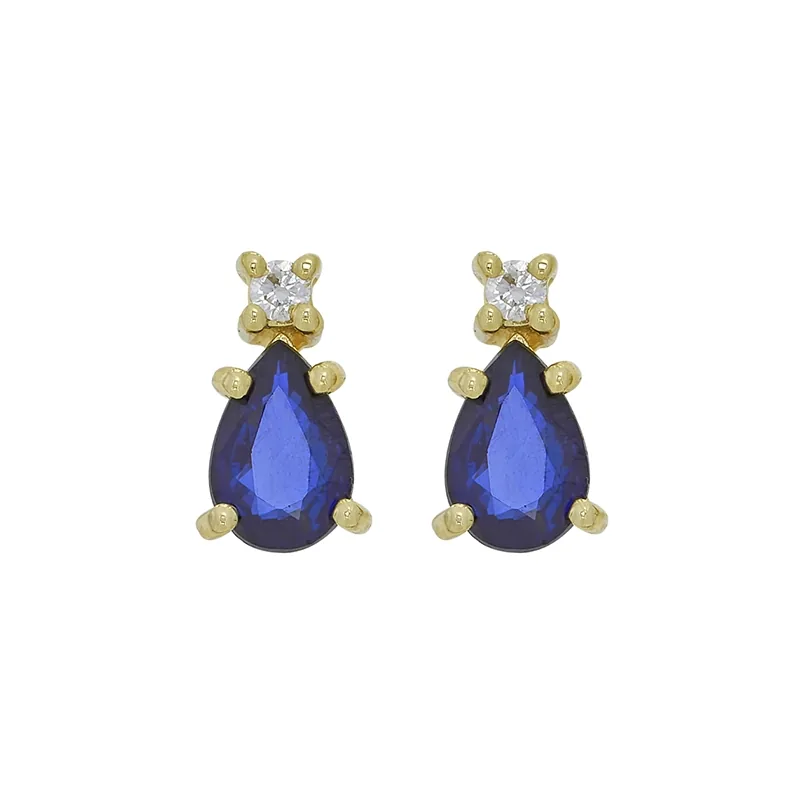 Topos en oro amarillo de 18 Kilates, con 2 zafiros centrales de 1.00 Ct y decoración en diamantes de 0.04 Ct