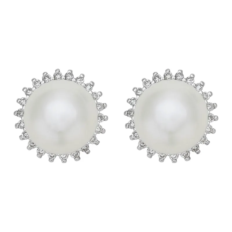 Topos en oro blanco de 18 Kilates, Flores, con perlas centrales de 7 mm de ancho aprox y decoración en diamantes de 0.14 Ct