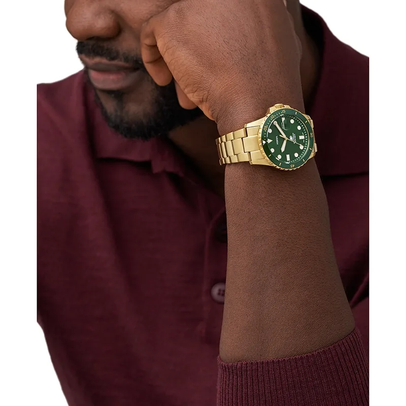 Reloj Fossil analogo, para Hombre, tablero redondo color verde, estilo index + puntos, pulso acero color dorado, calendario