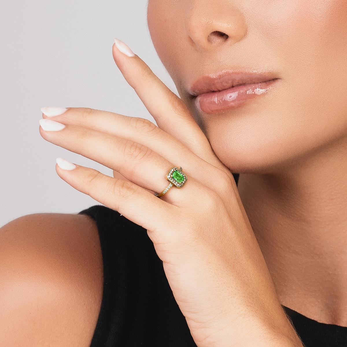 Anillo en oro amarillo de 18 Kilates, con esmeralda central de 0.60 Ct y decoración en diamantes de 0.15 Ct
