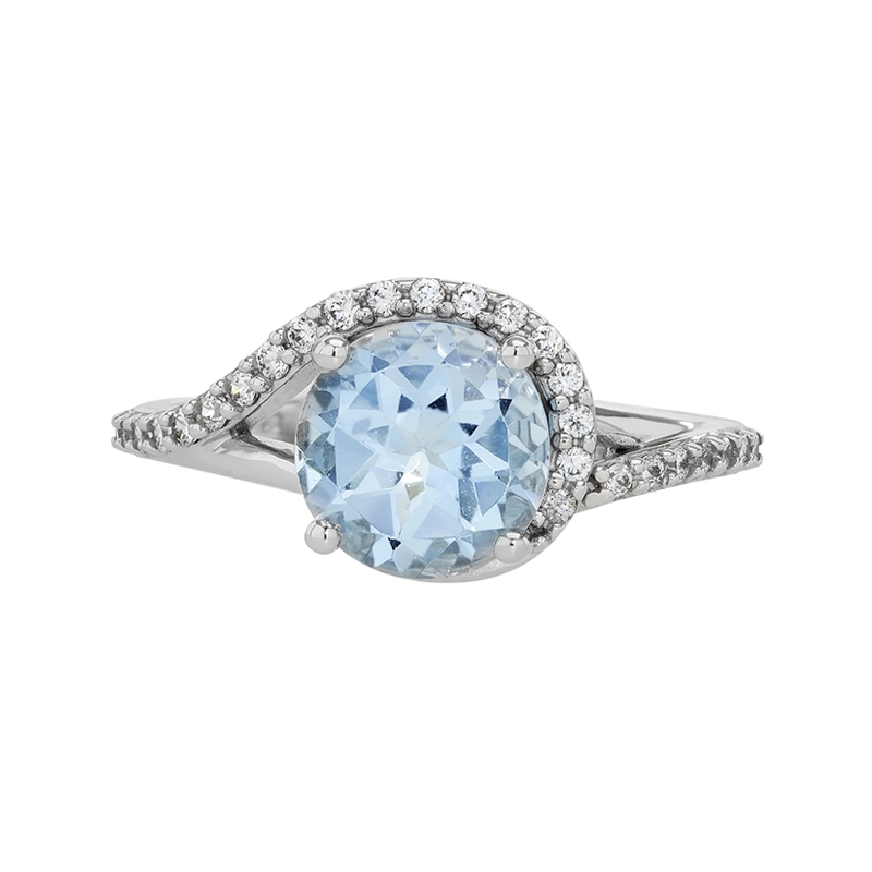 Anillo en oro blanco de 18 Kilates, con topacio central y decoración en zircones