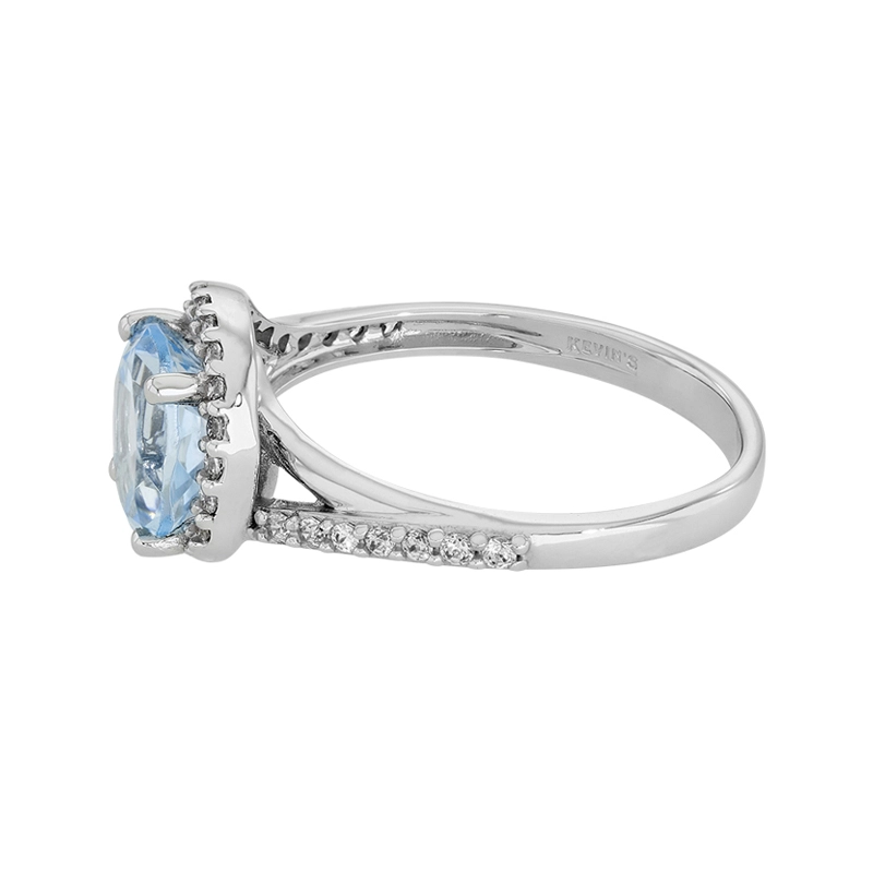 Anillo en oro blanco de 18 Kilates, con topacio central y decoración en zircones