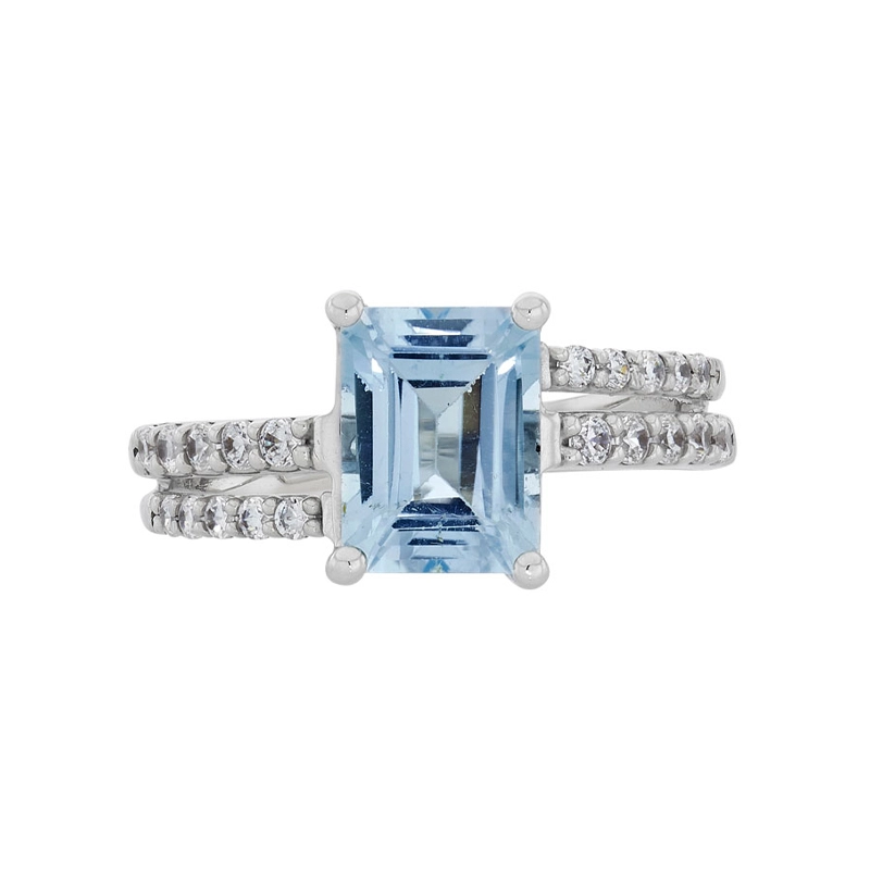 Anillo en oro blanco de 18 Kilates, con topacio central y decoración en zircones