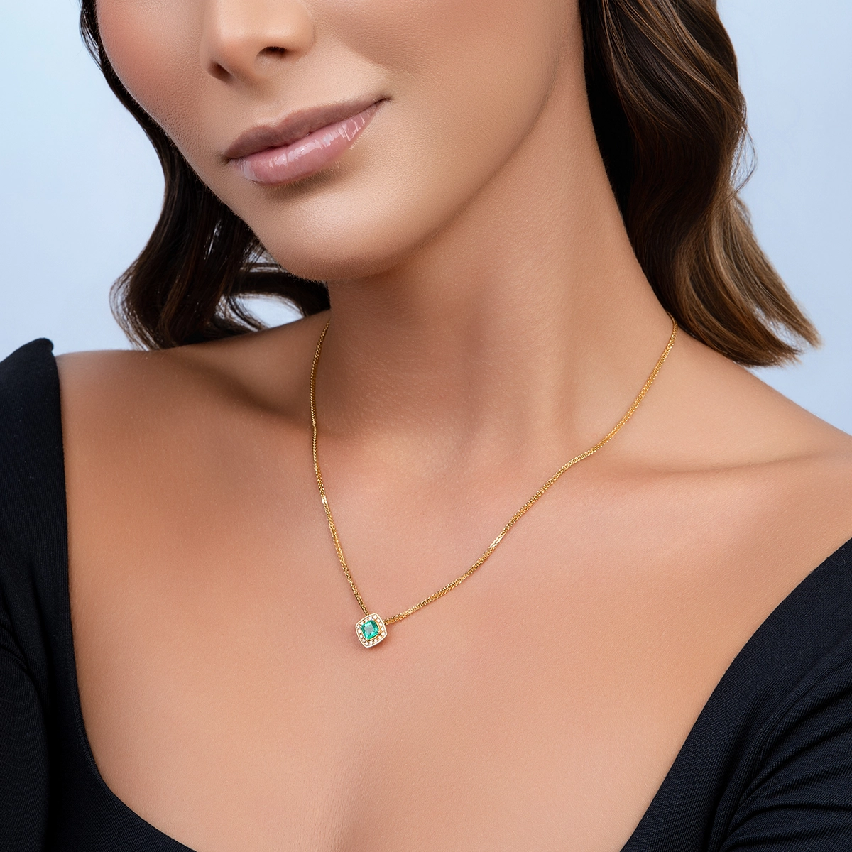 Dije en oro amarillo de 18 Kilates, Uñas+decoración, con esmeralda central de 0.65 Ct y decoración en diamantes de 0.08 Ct